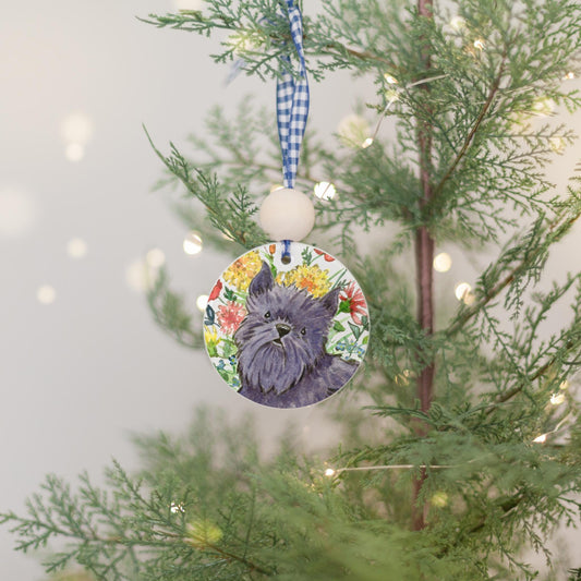 Black Brussels Griffon dog with flowers on a ceramic ornament.