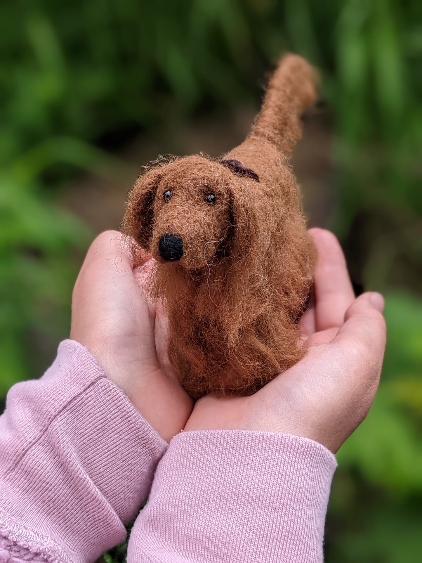 Irish setter dog needle felted wool sculpture held in child's hands