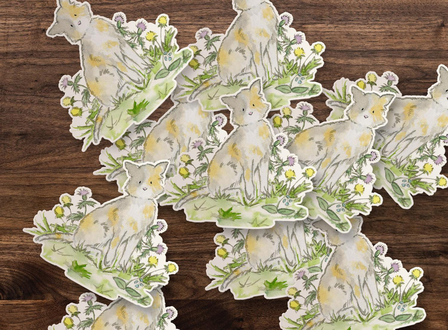Set of nature-themed stickers with cats and plants on a wooden surface