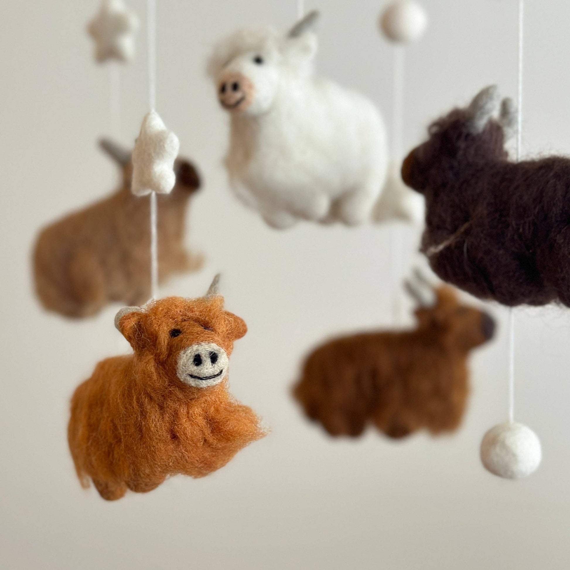 baby mobile with 5 needle felted wool highland cows in different colors