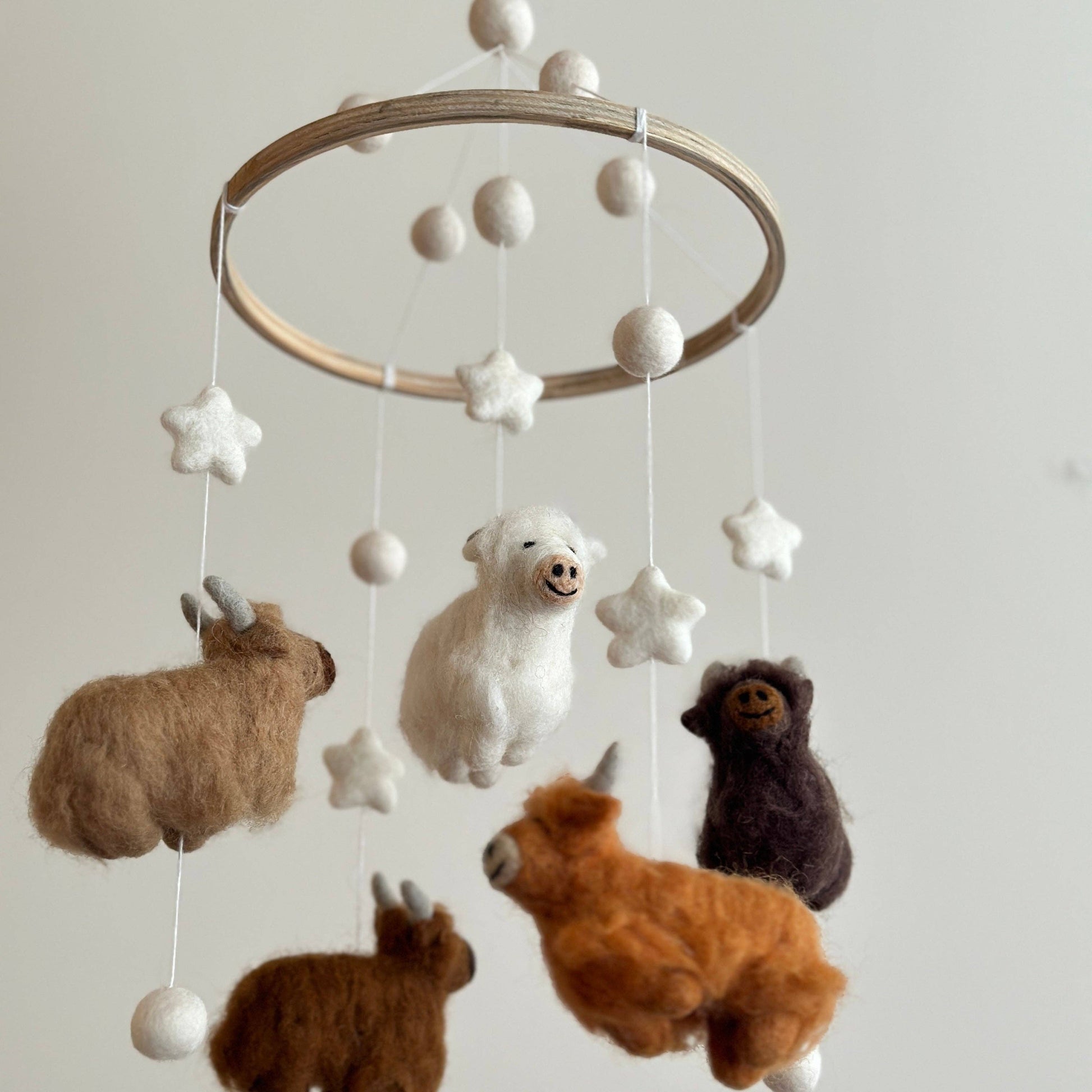 baby mobile with 5 needle felted wool highland cows in different colors