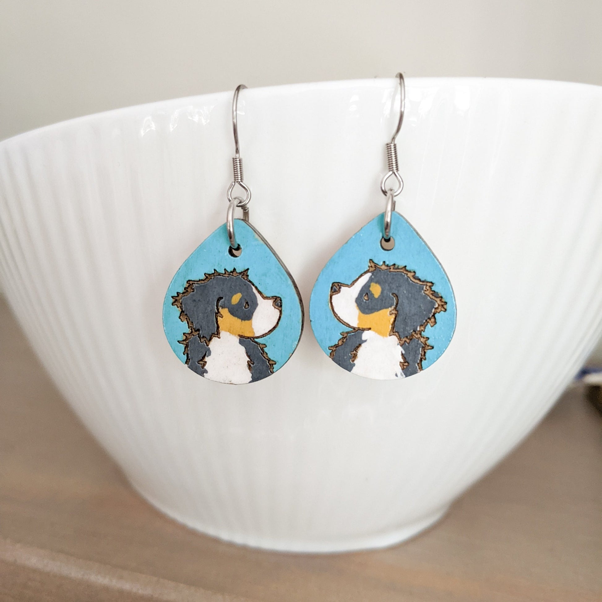 Hand-painted Bernese Mountain Dog Earrings made from laser engraved birch wood.