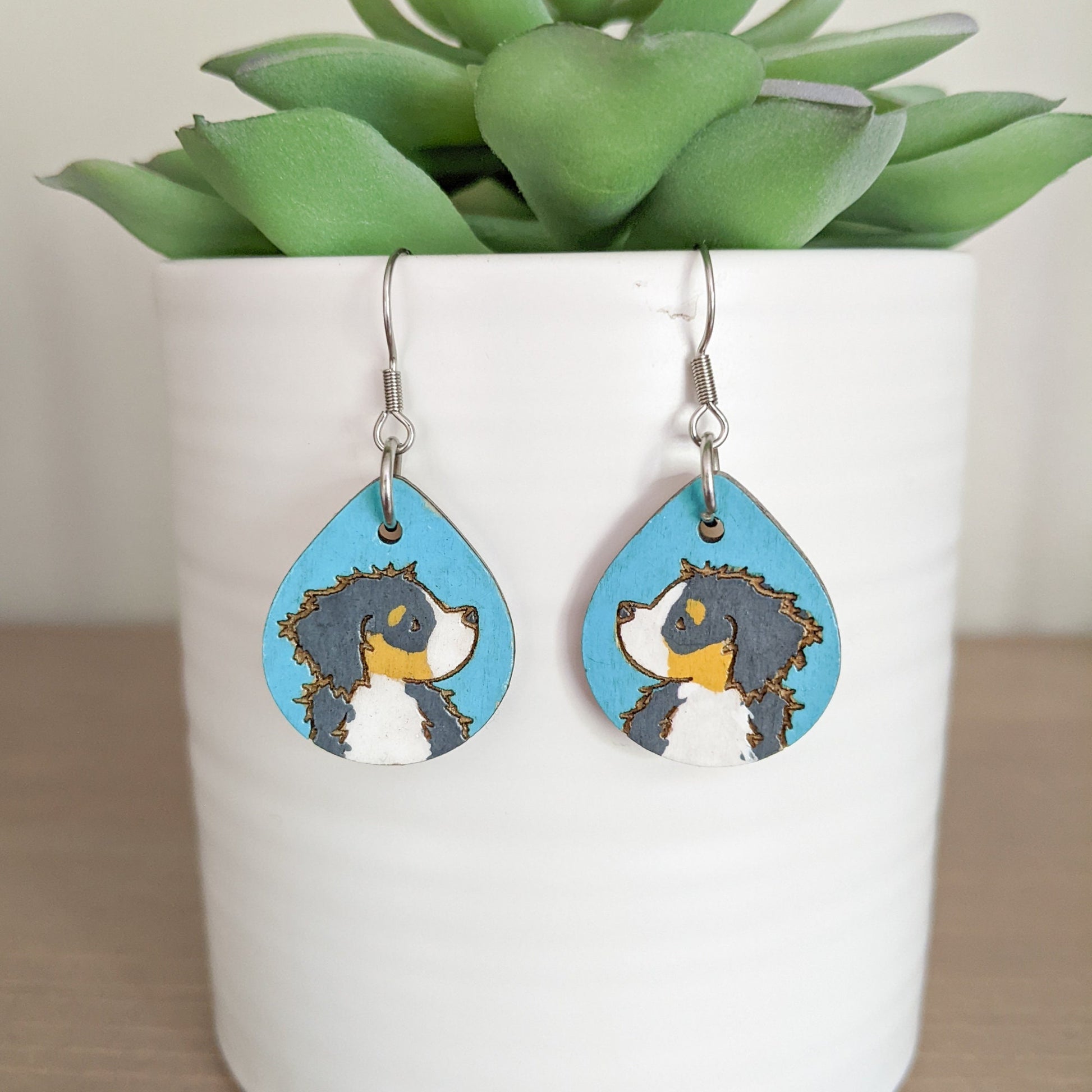 Hand-painted Bernese Mountain Dog Earrings made from laser engraved birch wood.