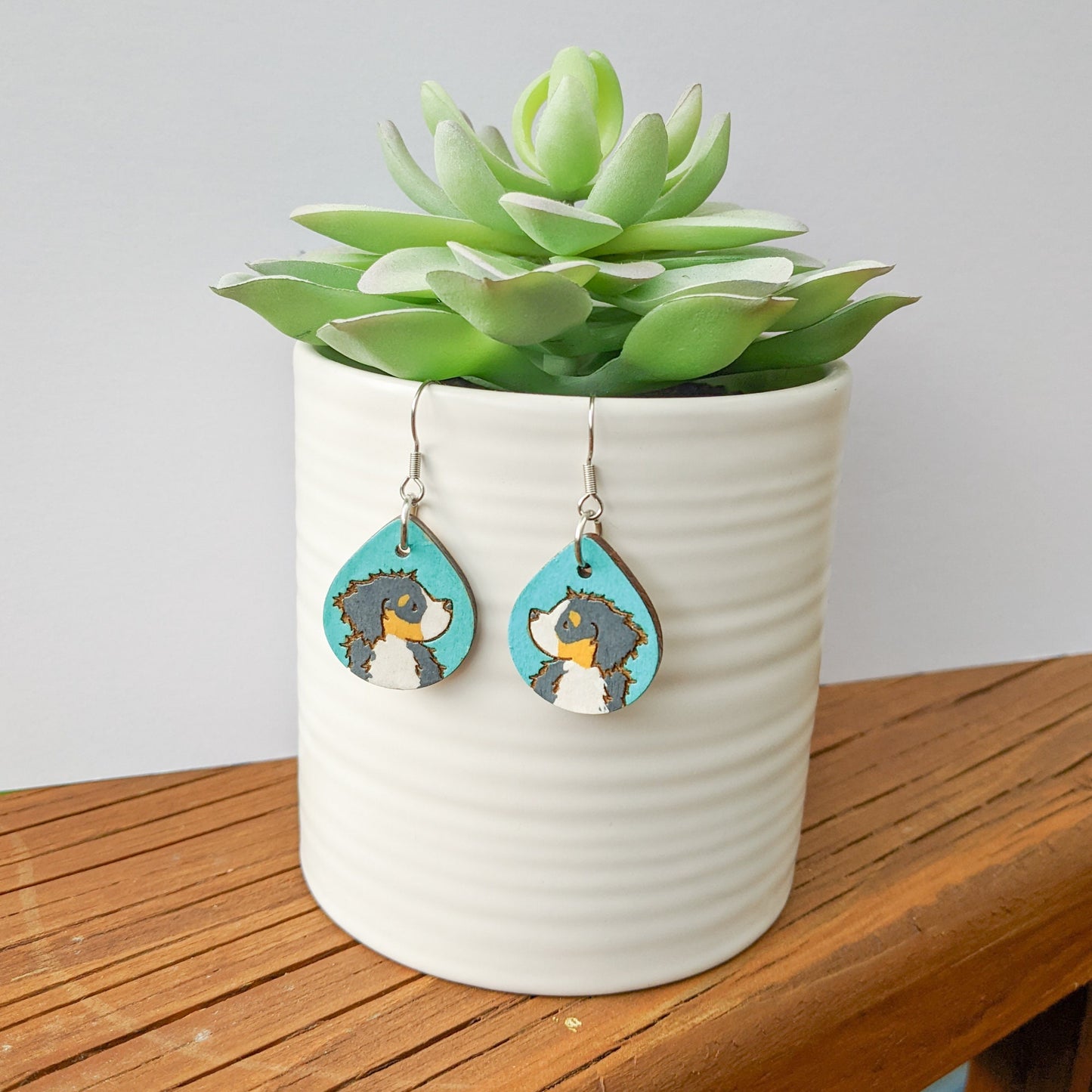 Hand-painted Bernese Mountain Dog Earrings made from laser engraved birch wood.