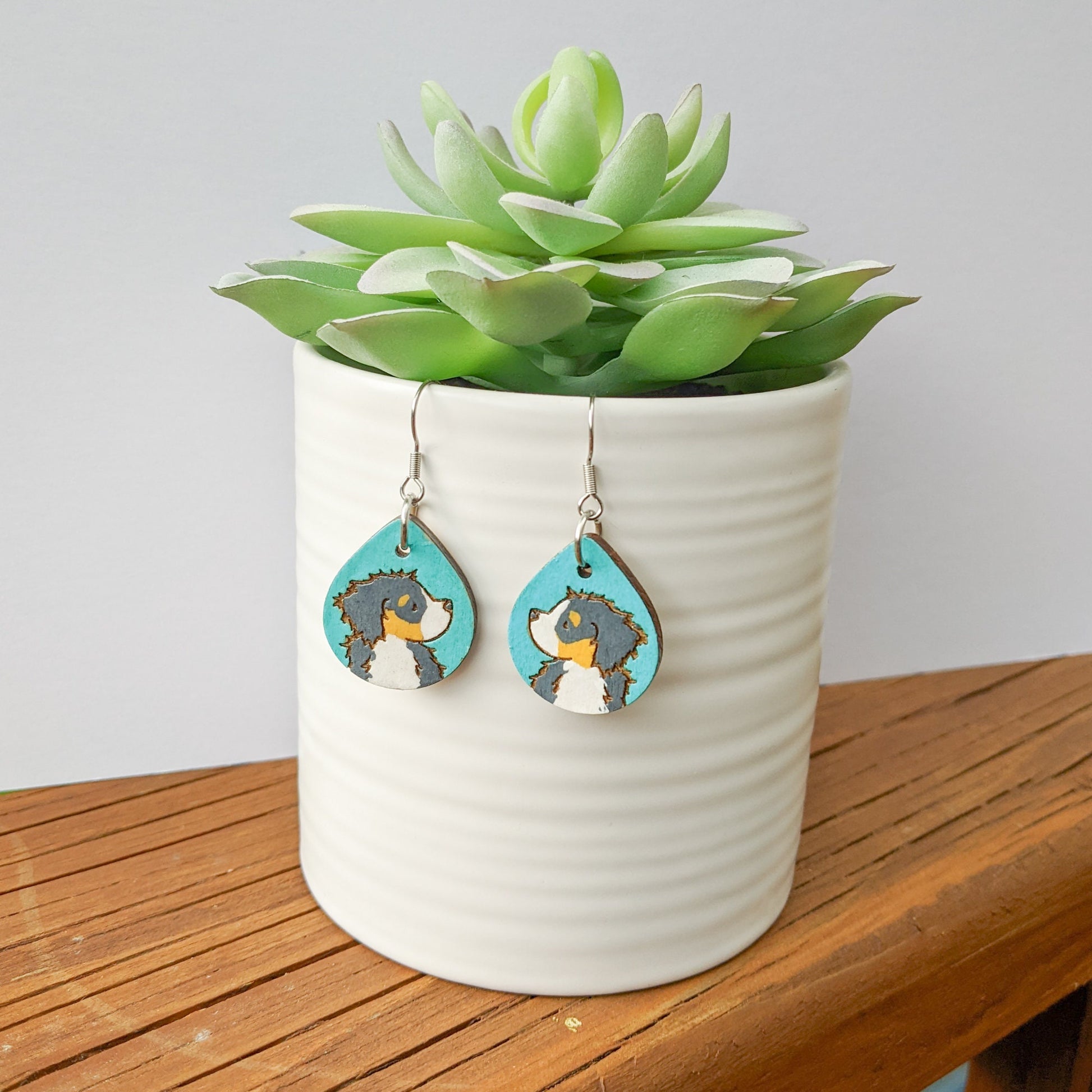 Hand-painted Bernese Mountain Dog Earrings made from laser engraved birch wood.