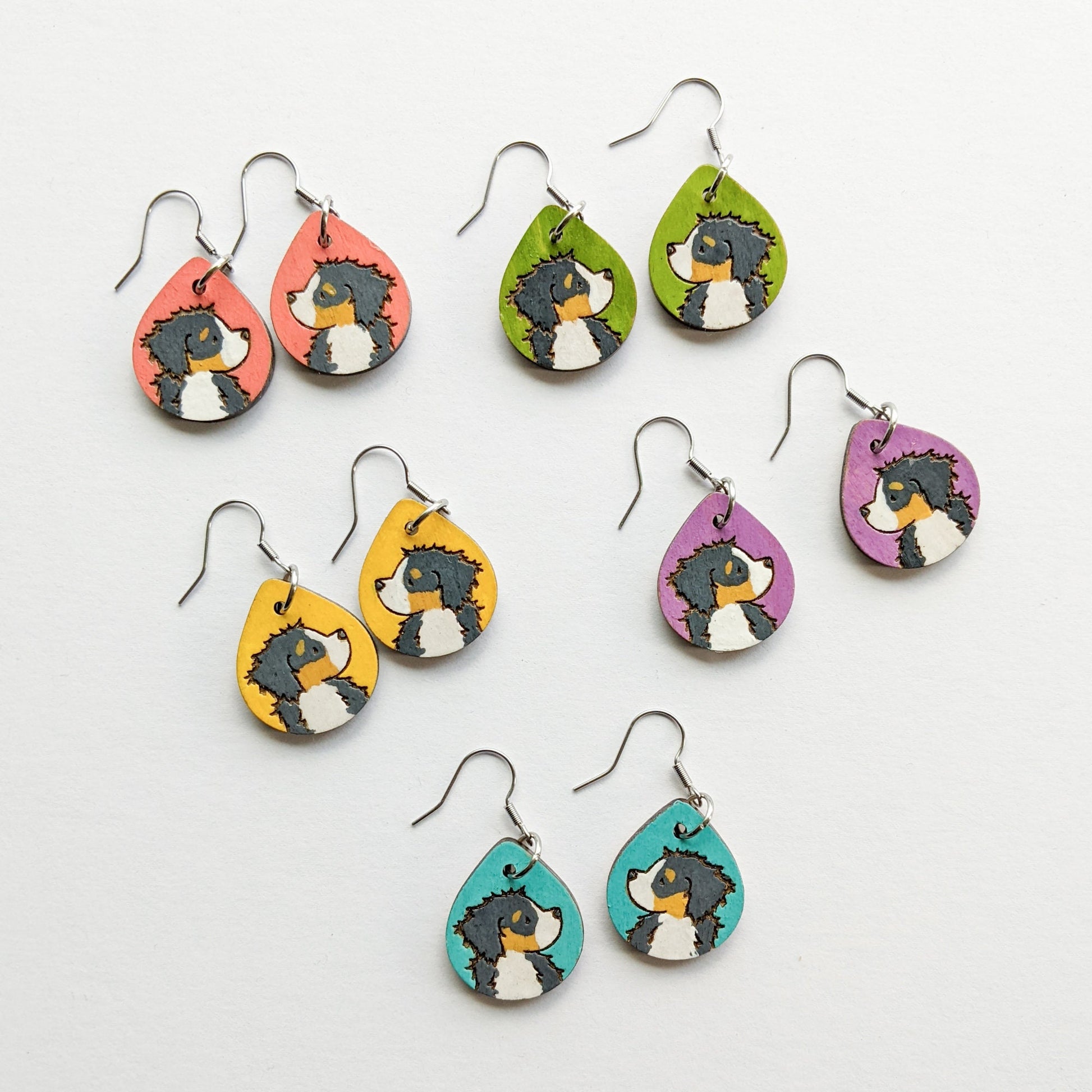 Hand-painted Bernese Mountain Dog Earrings made from laser engraved birch wood.