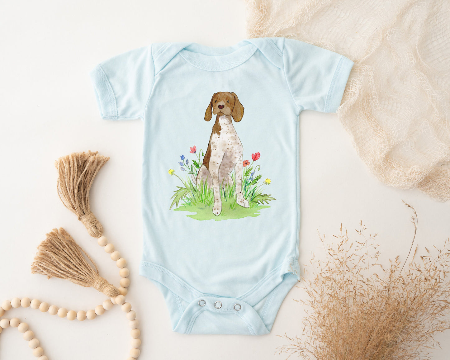 Cute baby bodysuit with German shorthaired pointer artwork on it.