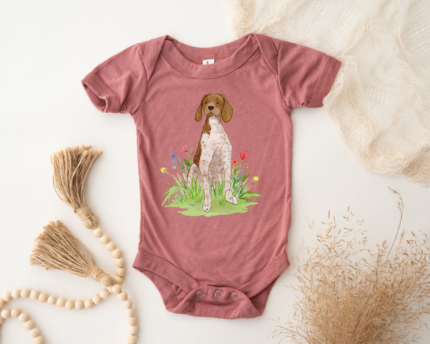 Cute baby bodysuit with German shorthaired pointer artwork on it.