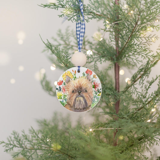 Red Brussels Griffon dog with flowers on a ceramic ornament.