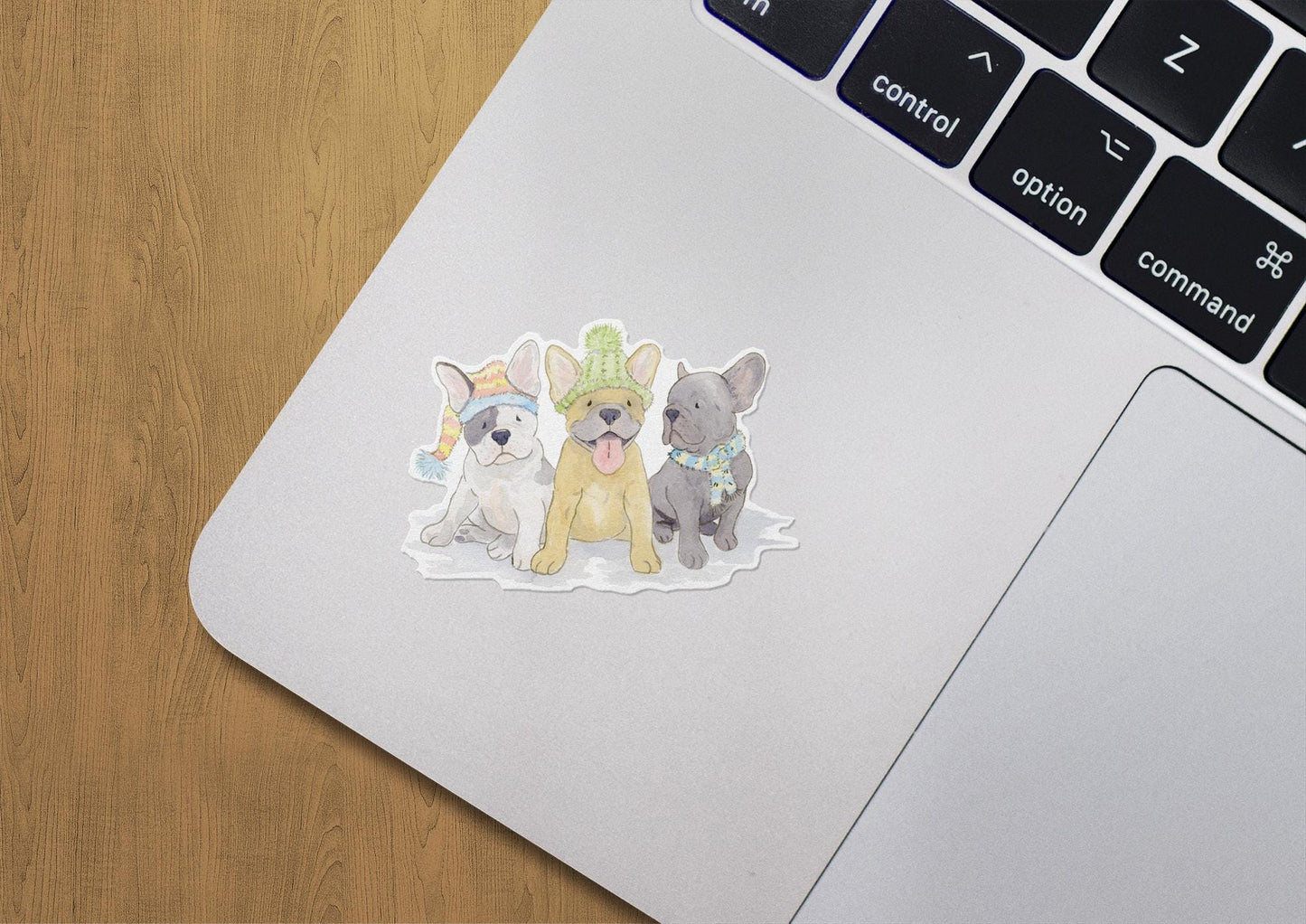 vinyl sticker with three Frenchie pups all wearing festive hats and scarves