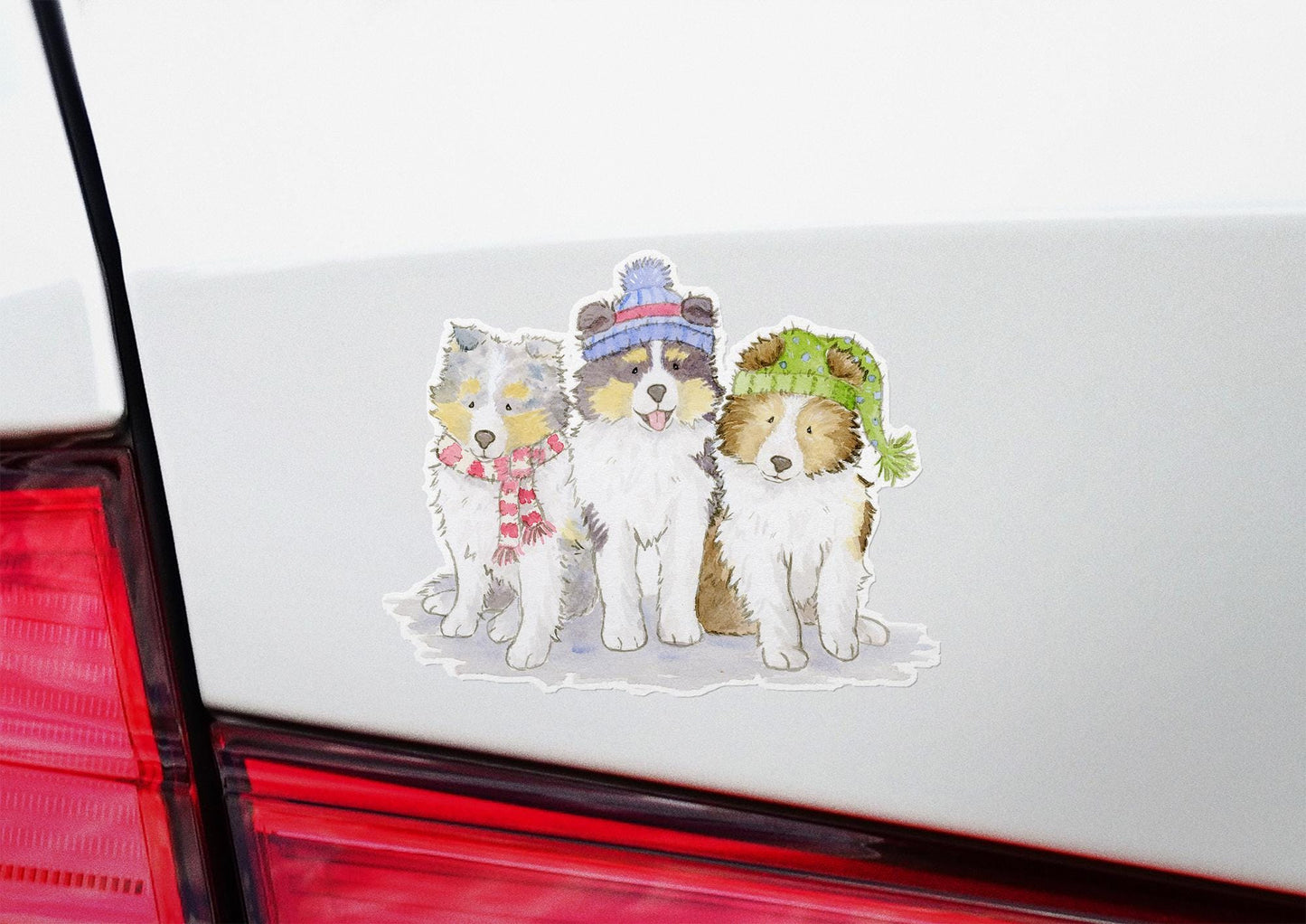 sheltie puppies wearing hats and scarves sticker