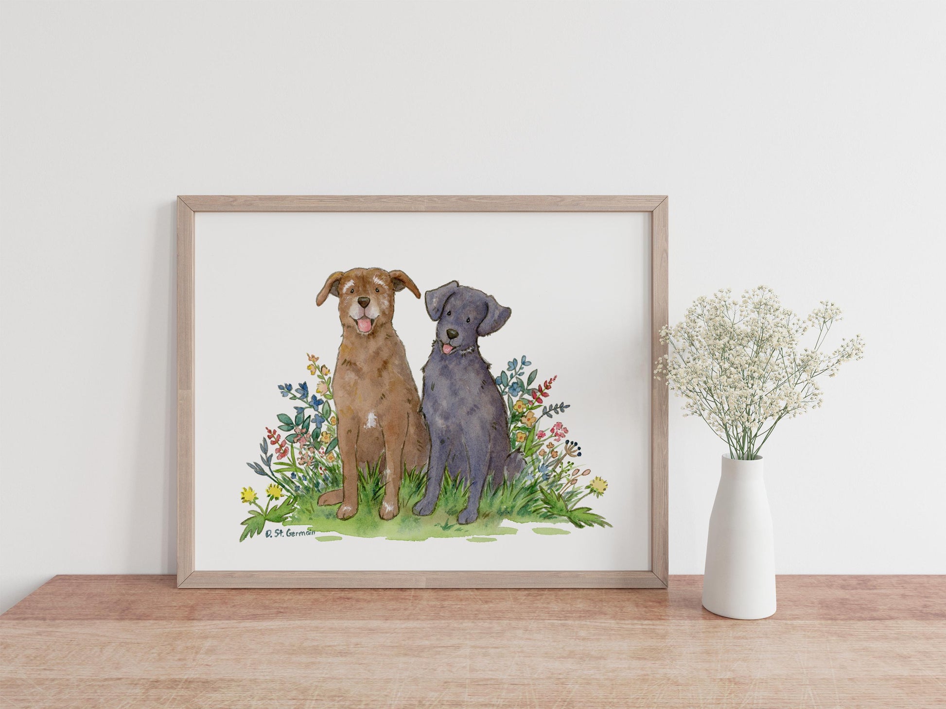 framed watercolor of a black lab and chocolate lab with flowers