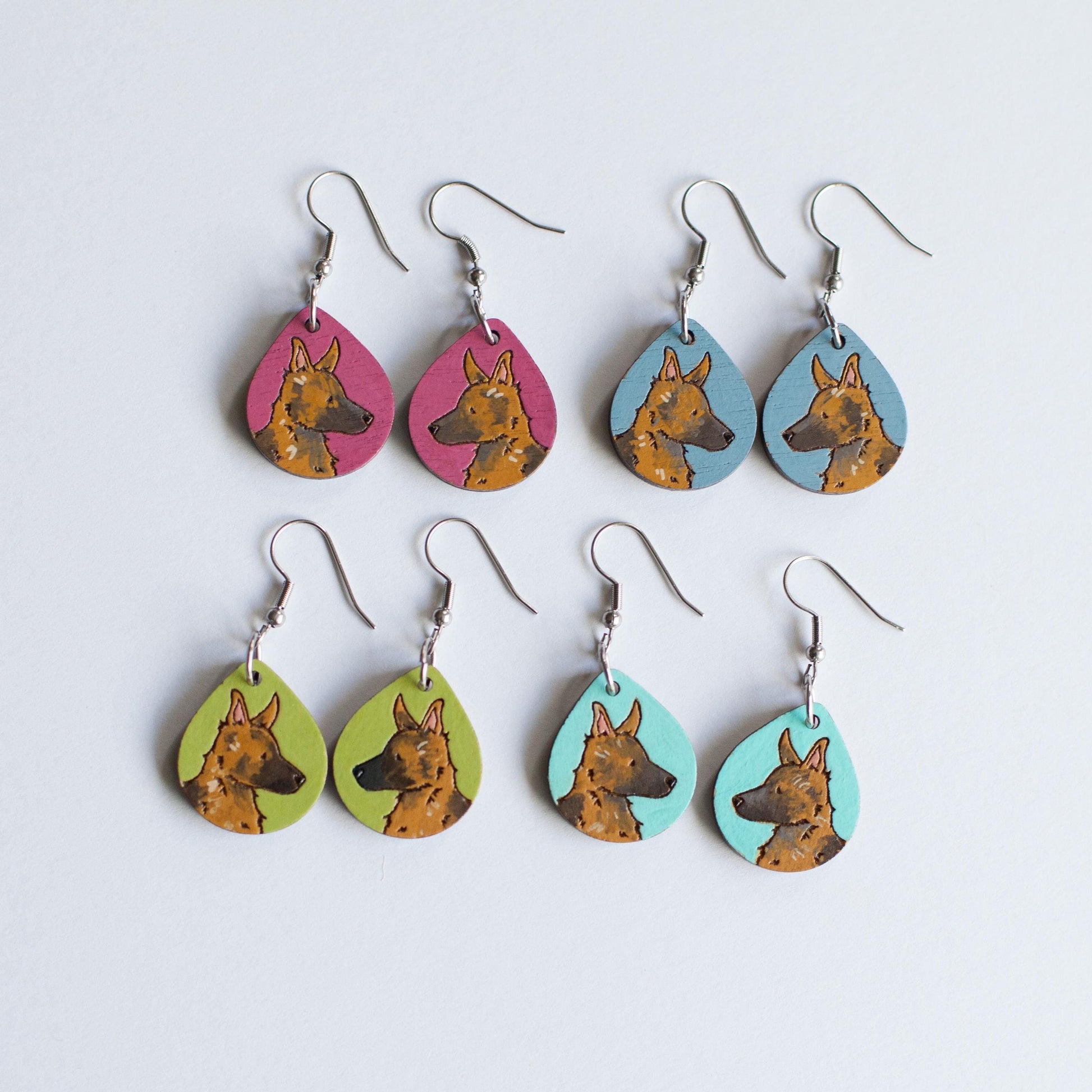 Hand painted wooden earrings with a German Shepherd dog face and various background colors