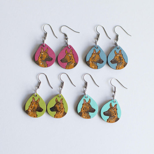 Hand painted wooden earrings with a German Shepherd dog face and various background colors