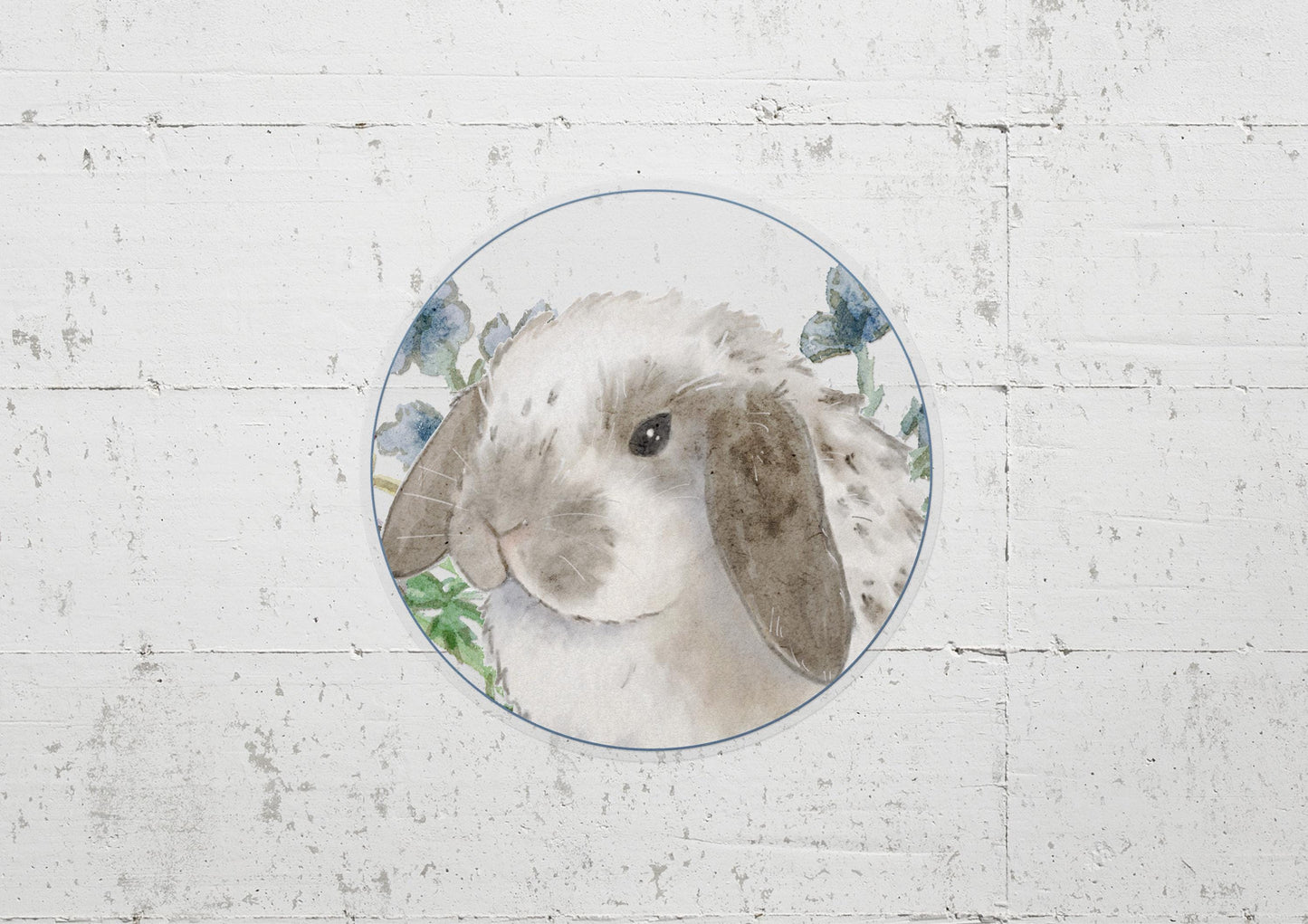 circle sticker of a gray and white holland lop bunny and flowers