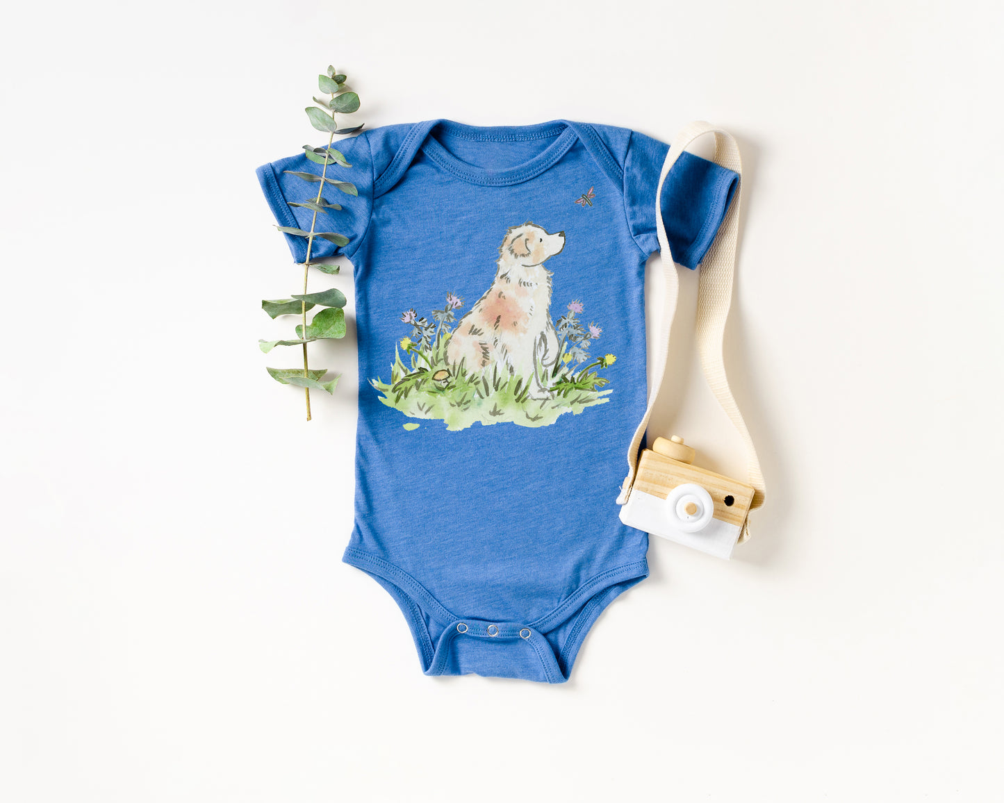 Blue baby onesie with a dog illustration on a white background
