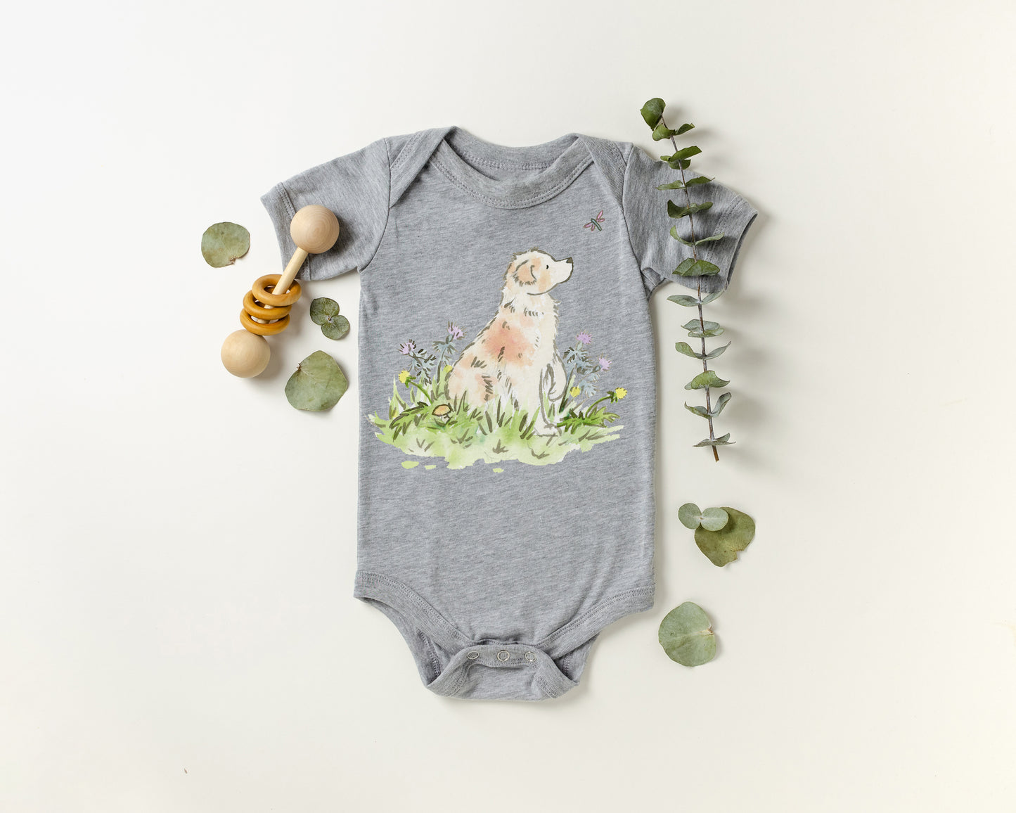 Gray baby onesie with a dog illustration on a white background