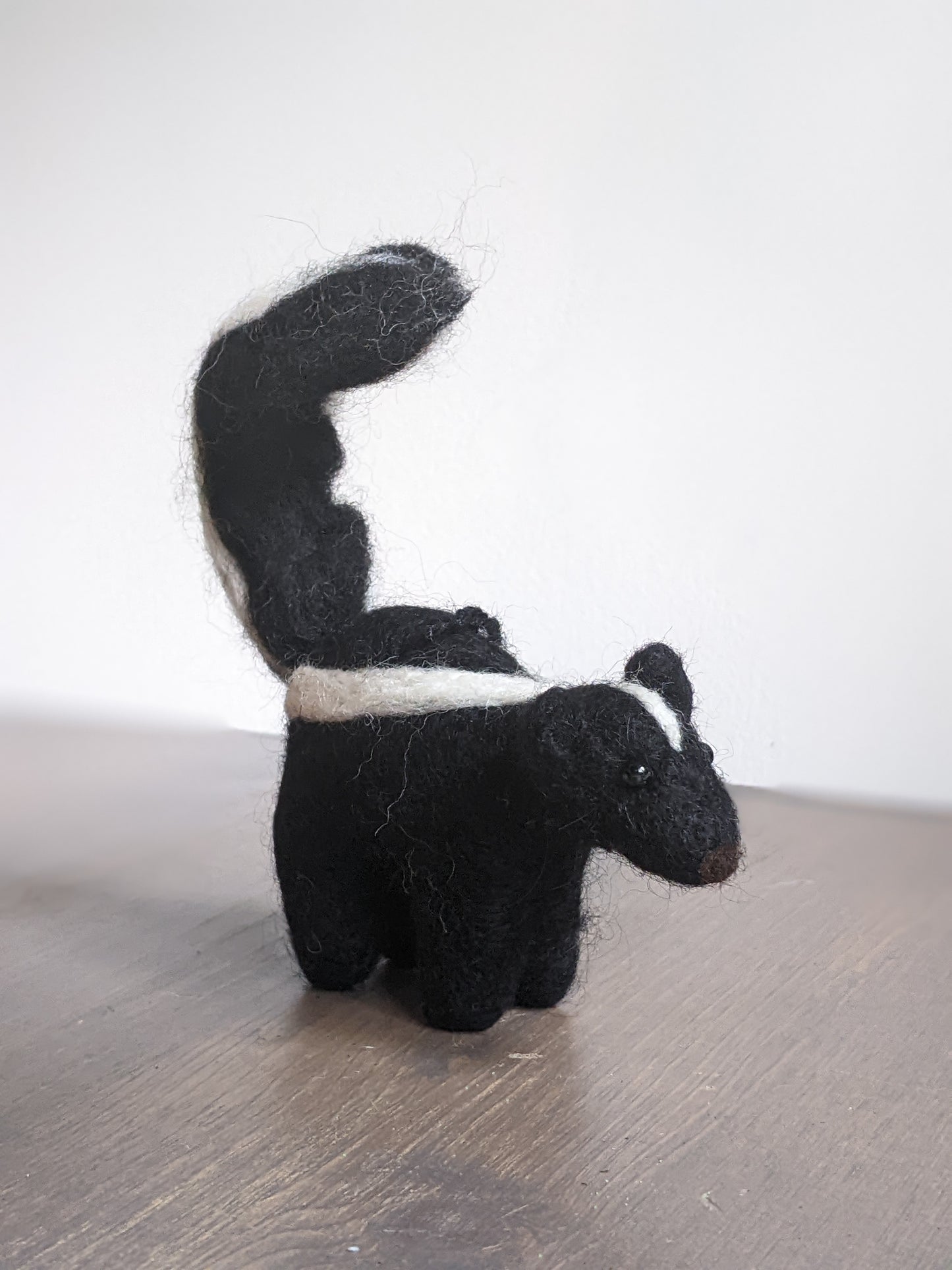 black and white needle felted wool skunk ornament