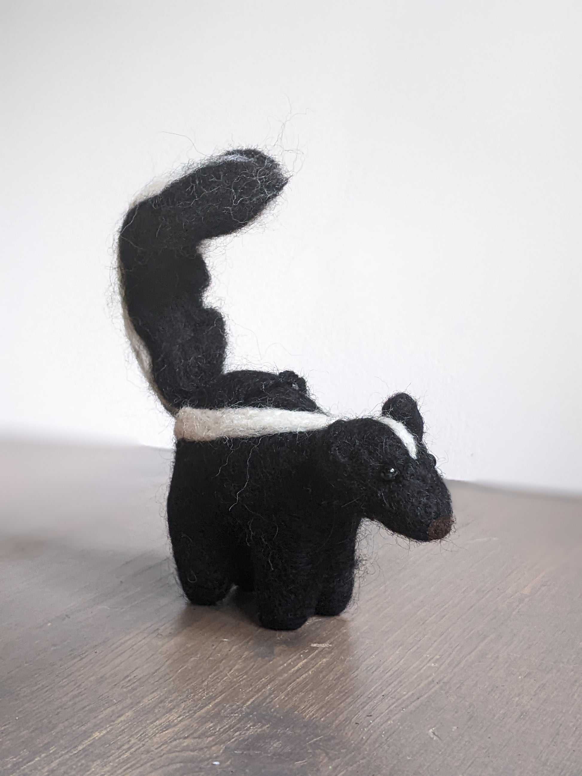 black and white needle felted wool skunk ornament