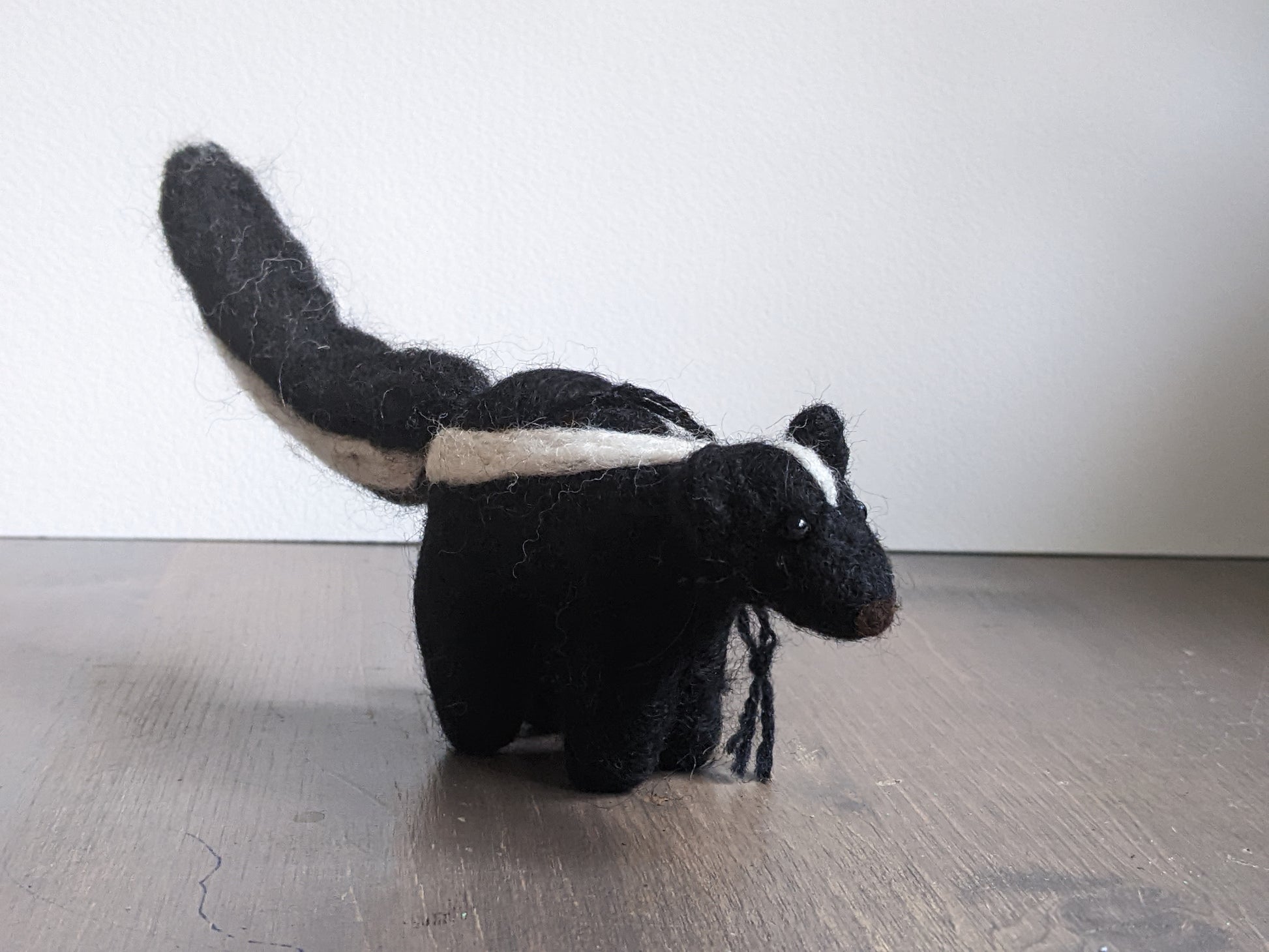 black and white needle felted wool skunk ornament