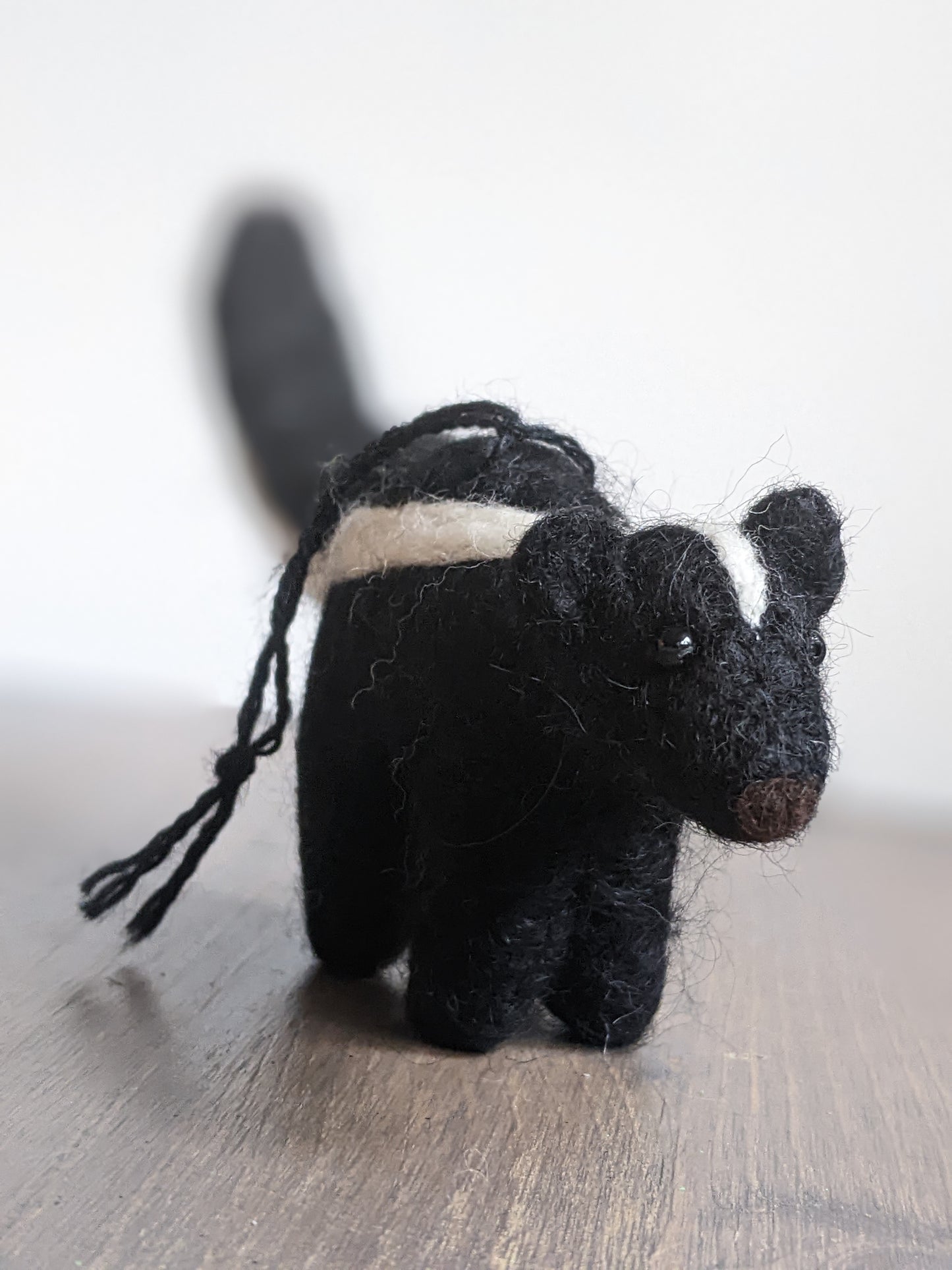 black and white needle felted wool skunk ornament
