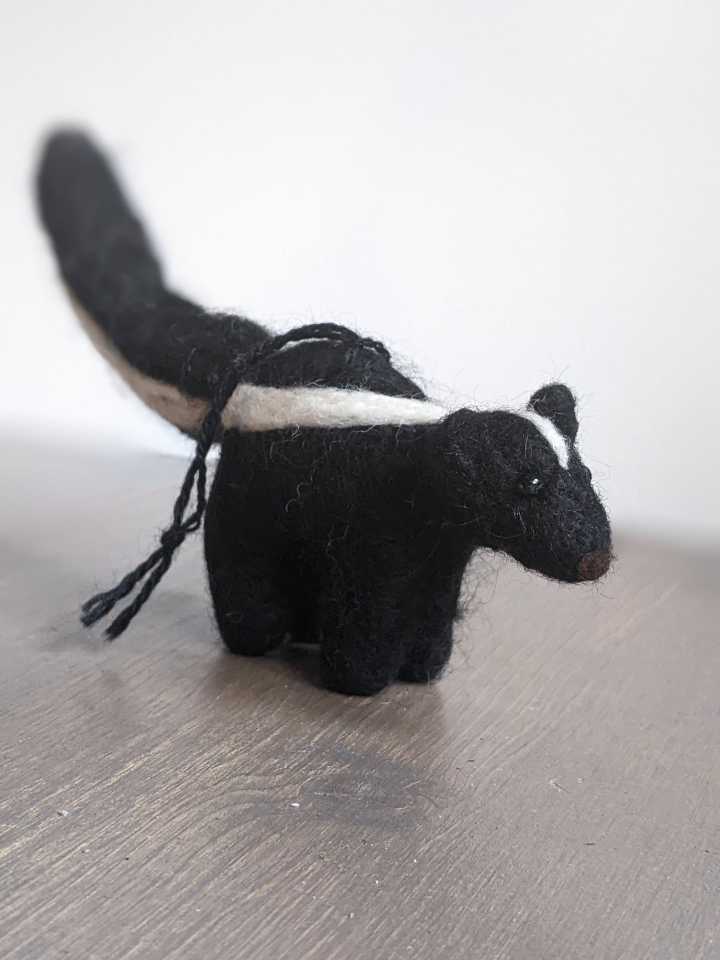 black and white needle felted wool skunk ornament
