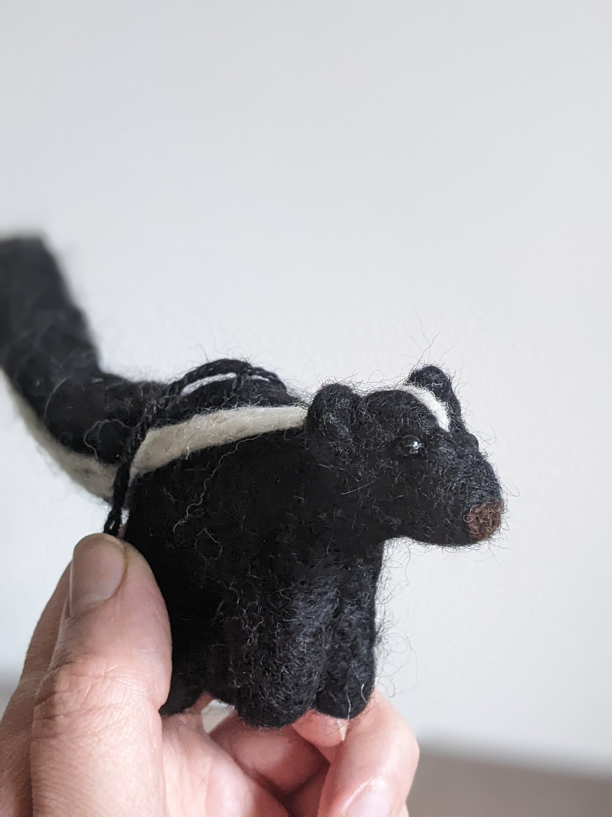 black and white needle felted wool skunk ornament