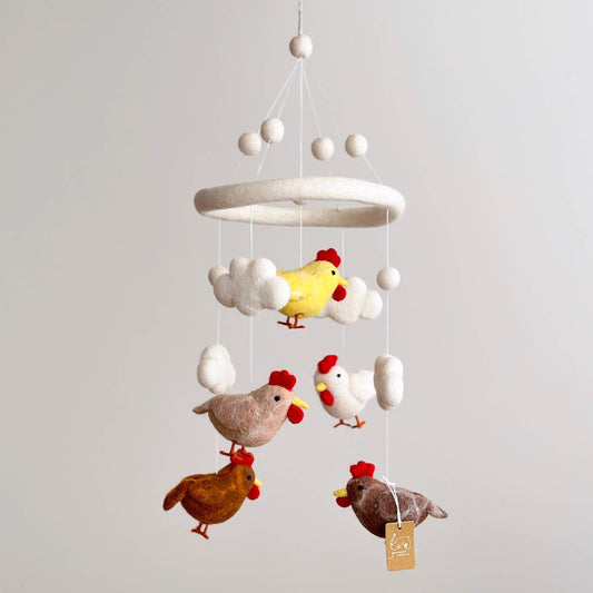 Hanging mobile with colorful chicken figures on a plain background