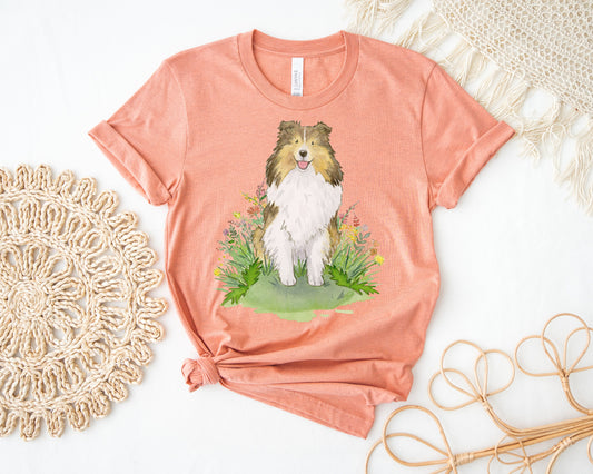 Pink orange t-shirt with cute shetland sheepdog artwork on it.