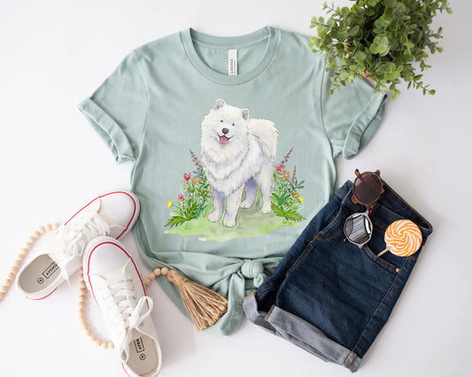Dusty blue t-shirt with cute, fluffy, white samoyed dog and colorful flowers on it.