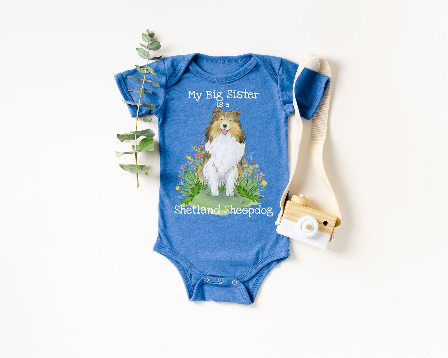 Baby bodysuit with cute sable sheltie puppy on it and "my big sister is a shetland sheepdog".