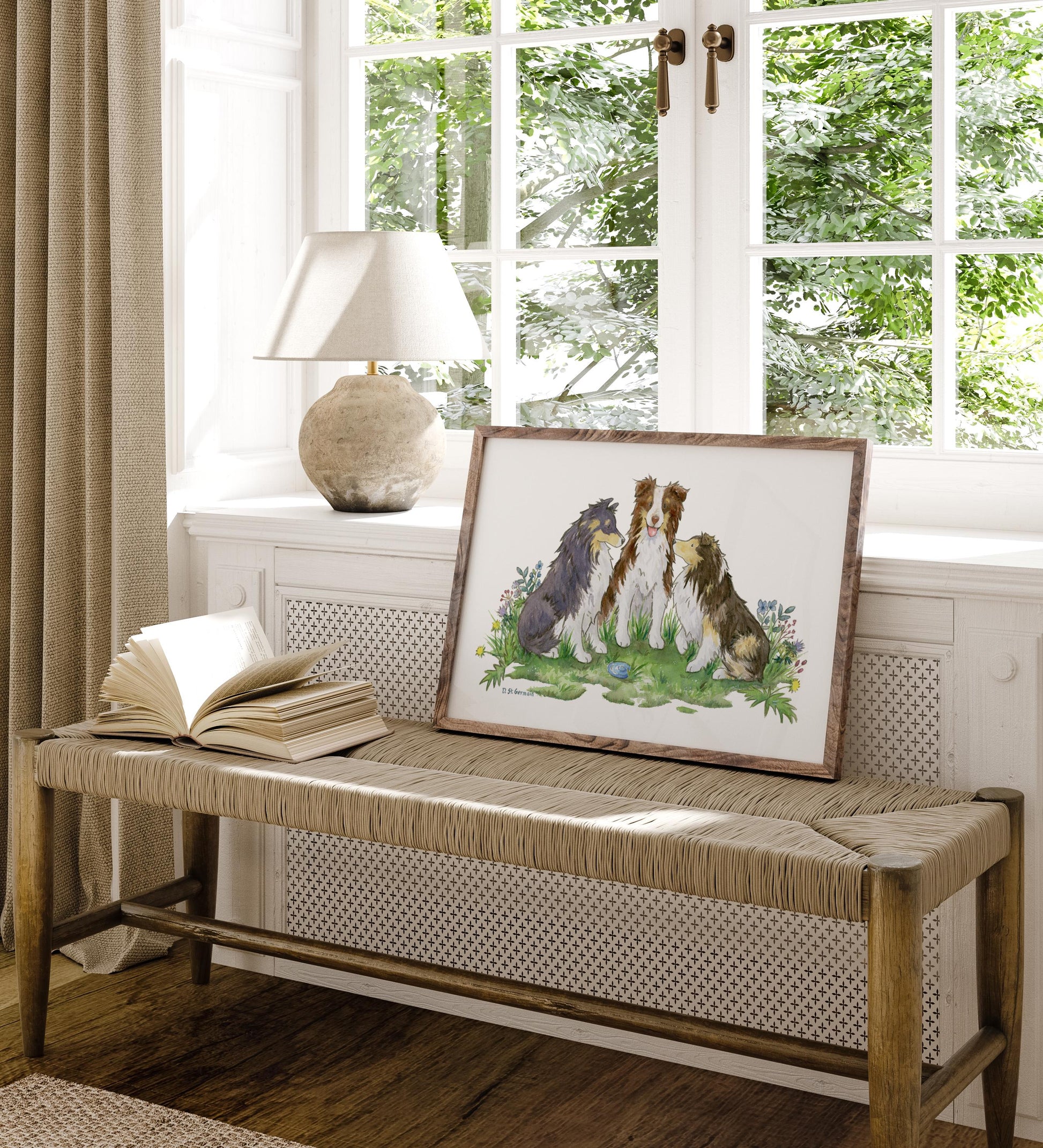 A framed painting of two cute shetland sheepdogs and an australian shepherd sitting in a patch of colorful flowers.