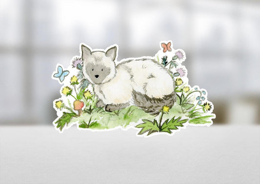 Sticker of a cat among flowers on a blurred background