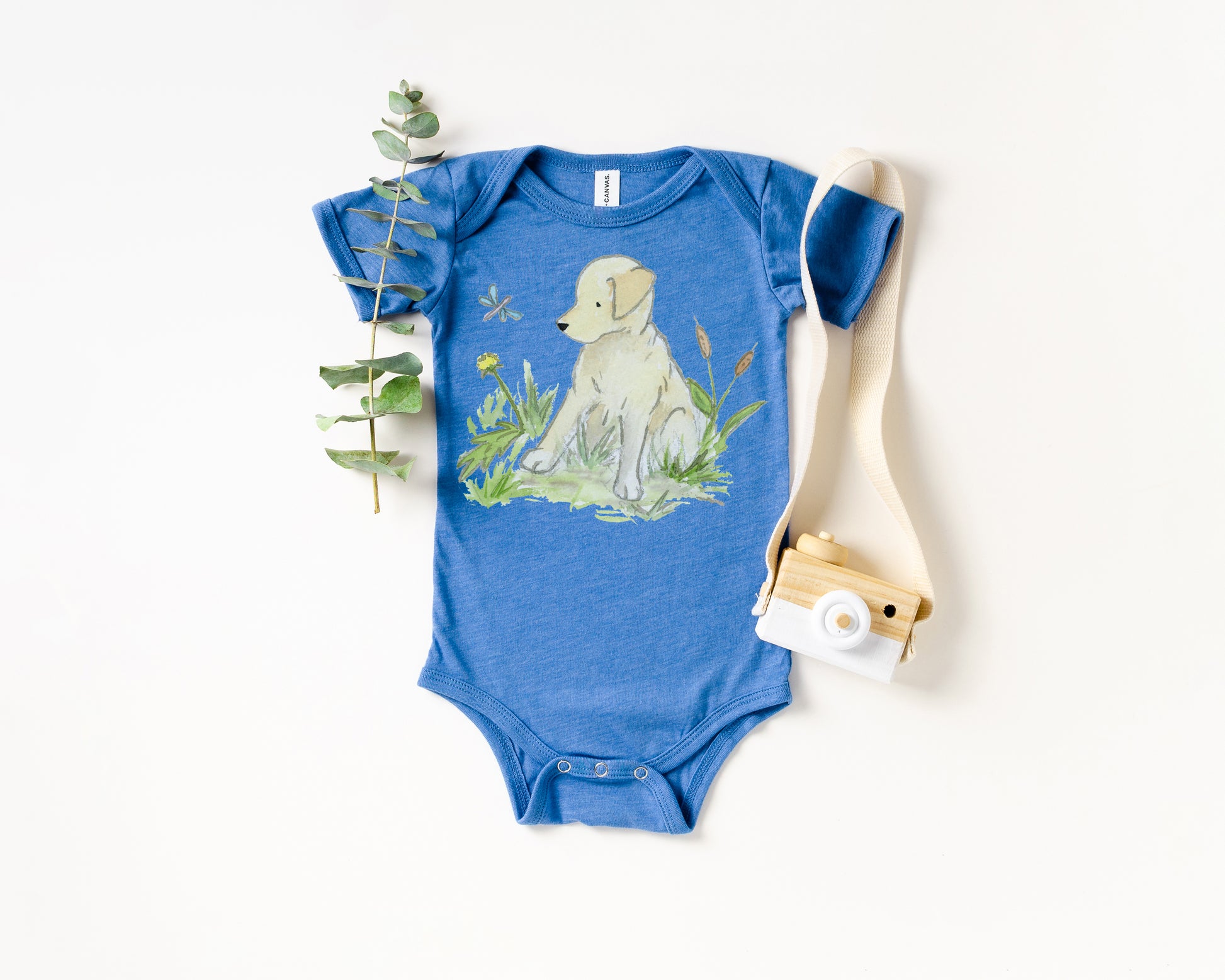 Blue baby onesie with a dog illustration on a white background