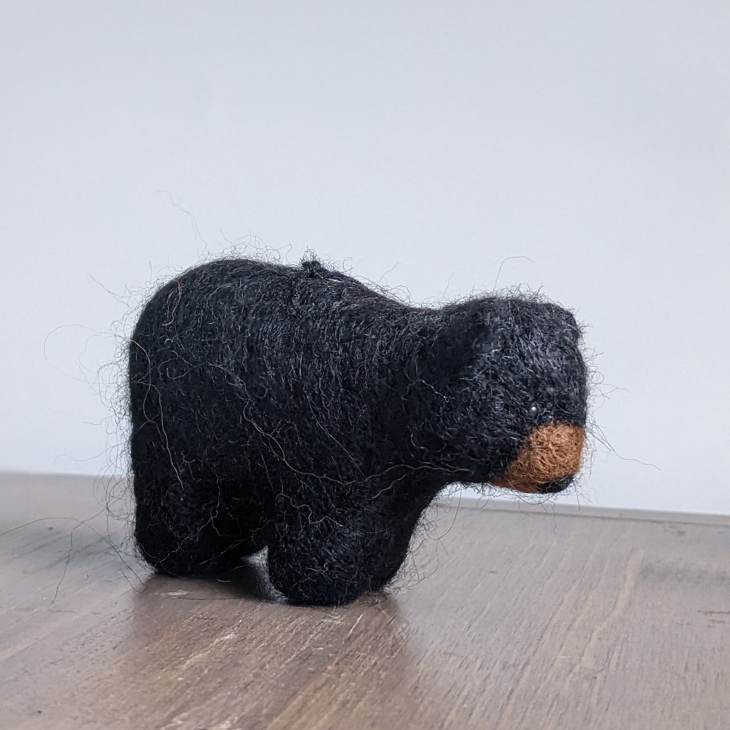needle felted wool black bear cub sculpture side view