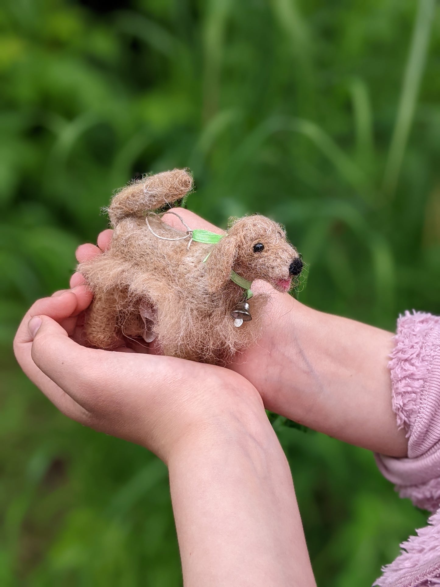golden retriever from needle felted wool held in child's hands