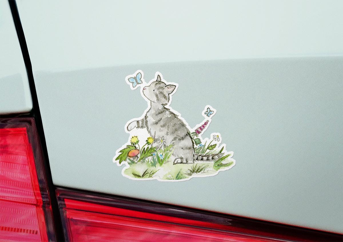 Sticker of a cat with flowers on a car window