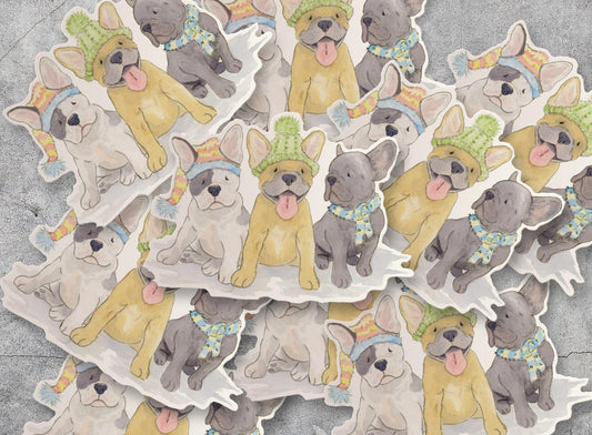 vinyl sticker with three  Frenchie pups all wearing festive hats and scarves