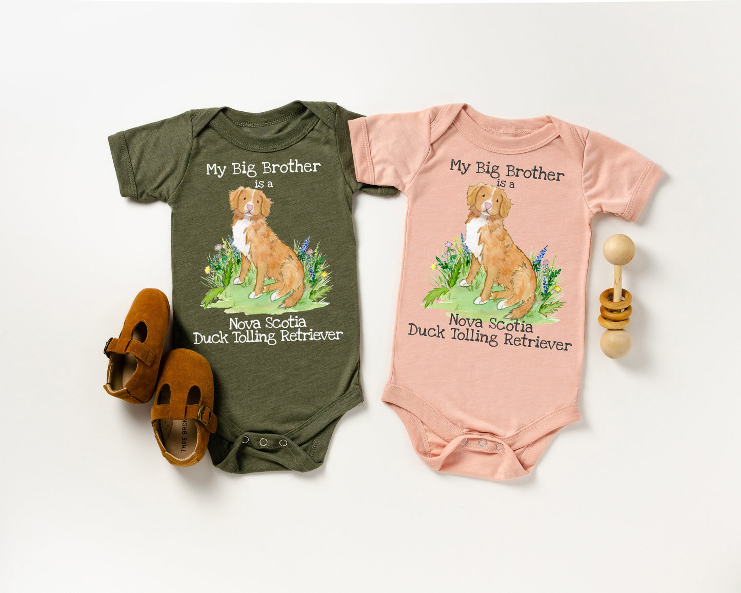 Baby one-piece bodysuit with cute artwork of a Nova Scotia Duck Tolling Retriever looking at a butterfly and the words, &quot;My big brother is a Nova Scotia Duck Tolling Retriever&quot; on it.