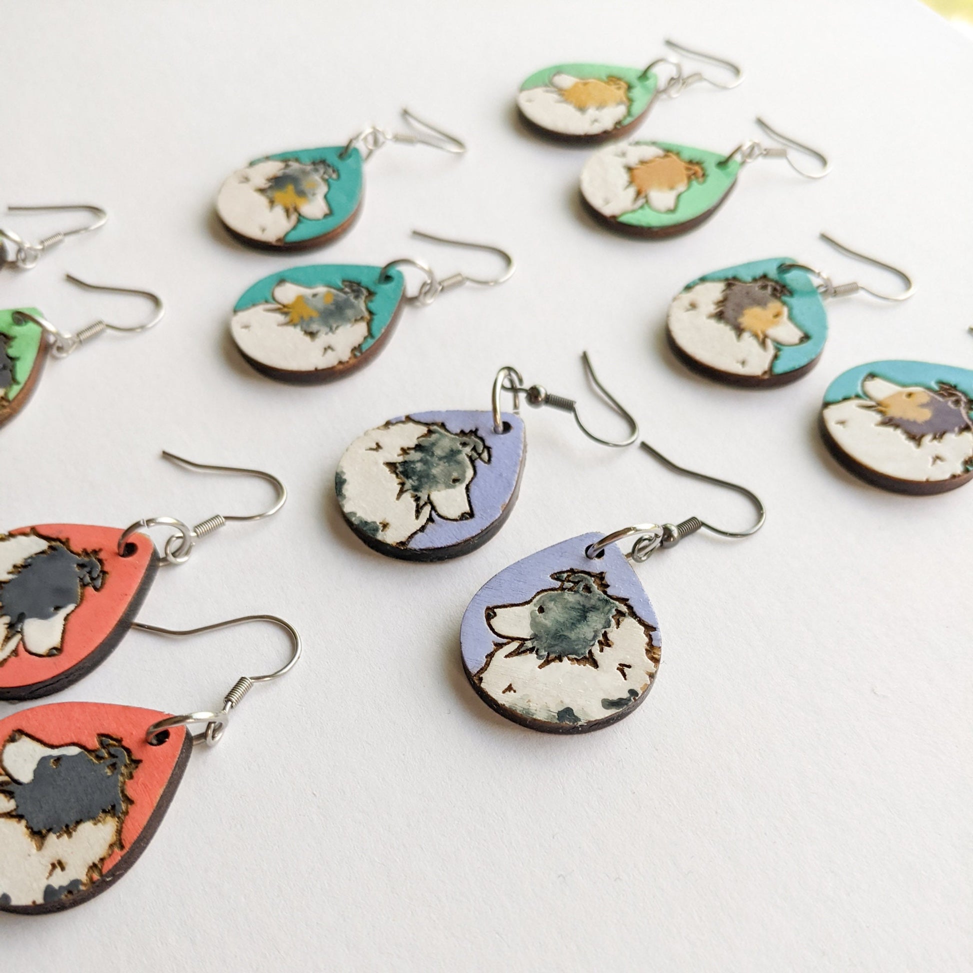 Hand painted, laser engraved sheltie earrings in a variety of coat colors.