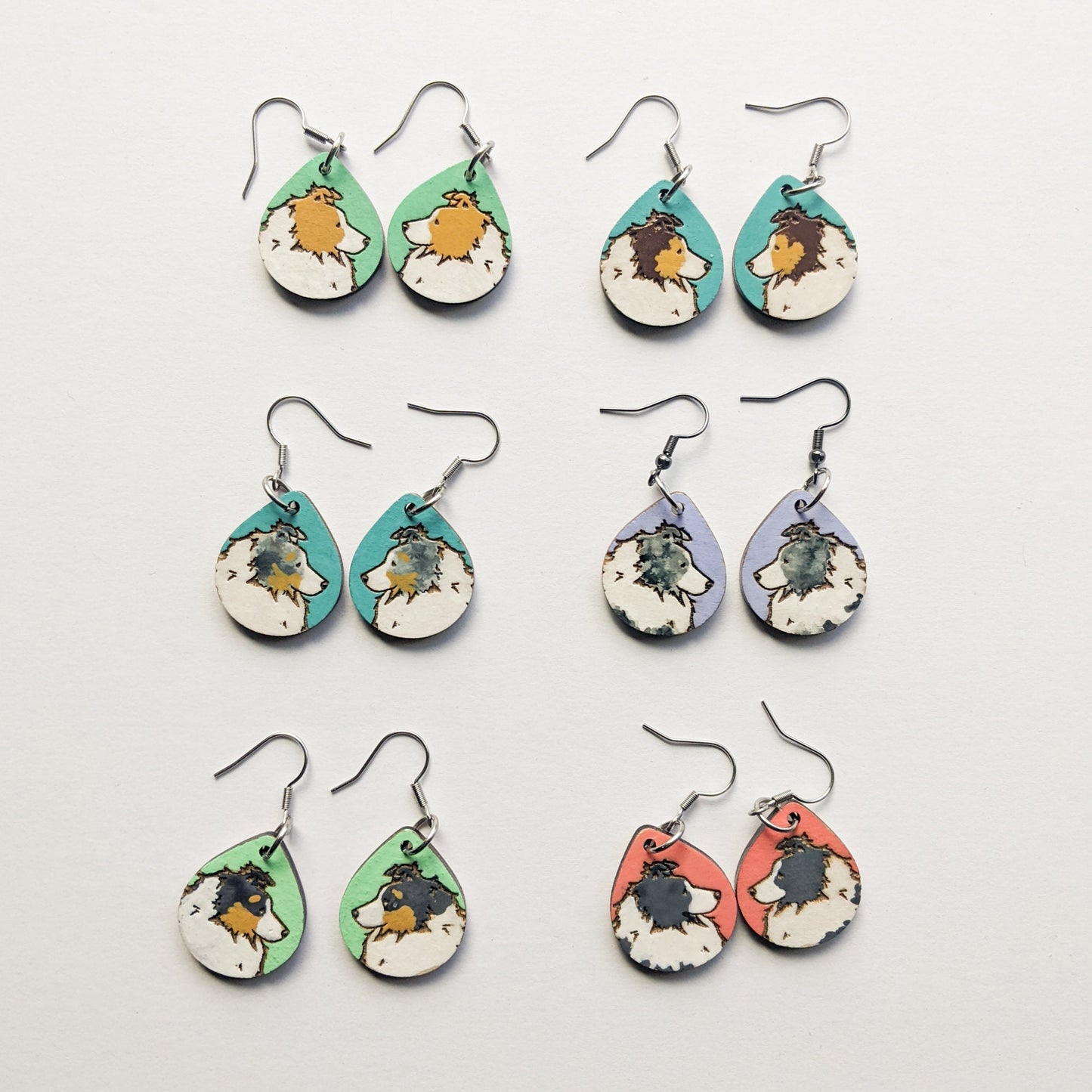 Hand painted, laser engraved sheltie earrings in a variety of coat colors.