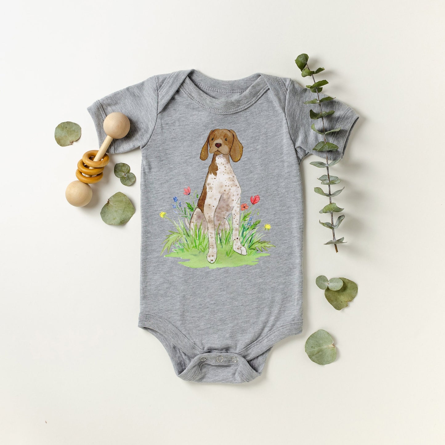 Cute baby bodysuit with German shorthaired pointer artwork on it.