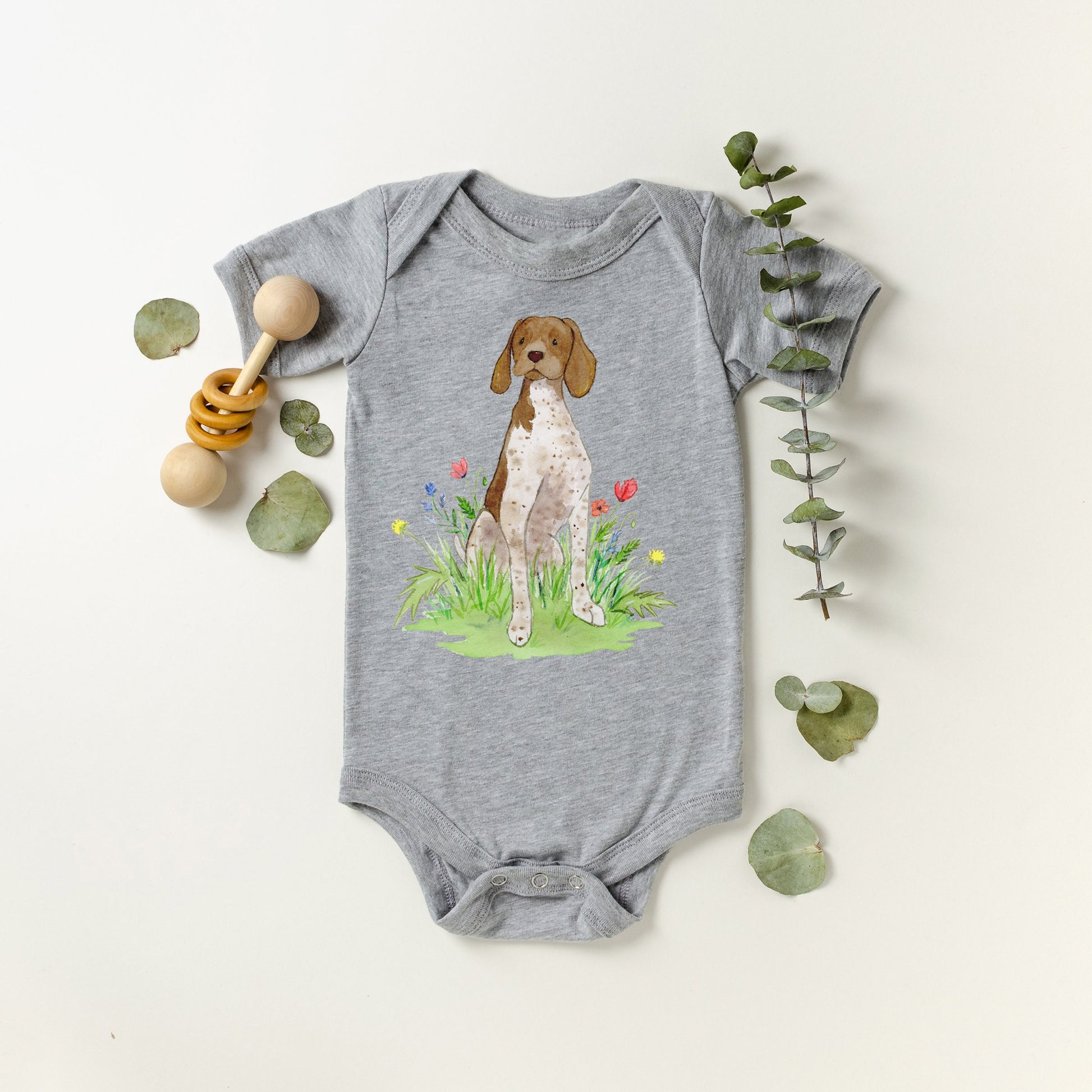 Cute baby bodysuit with German shorthaired pointer artwork on it.