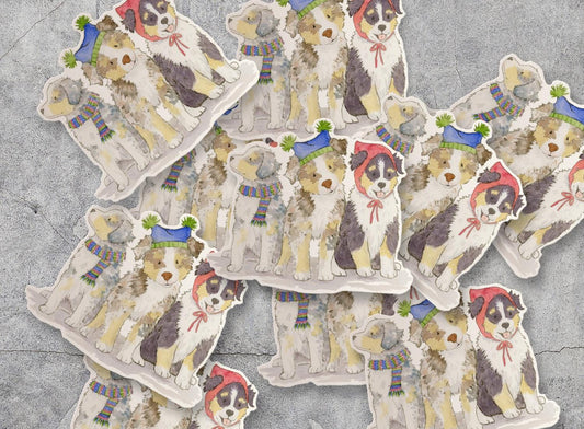 vinyl stickers with Australian Shepherd pups wearing festive hats and scarves