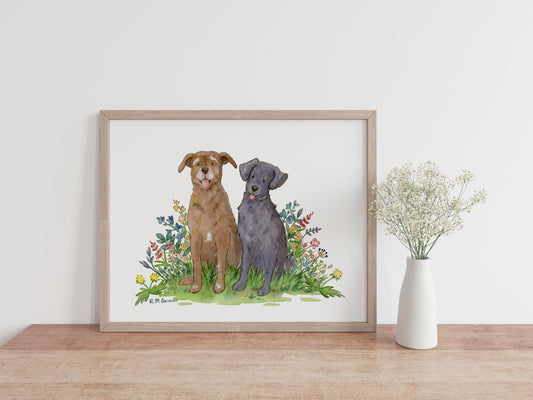 framed watercolor of a black lab and chocolate lab with flowers