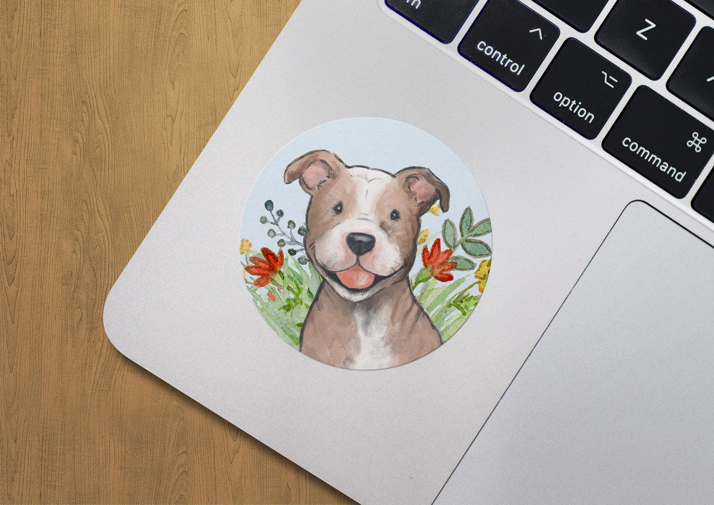 Circle sticker with a happy pitbull dog and flowers on a light blue background.