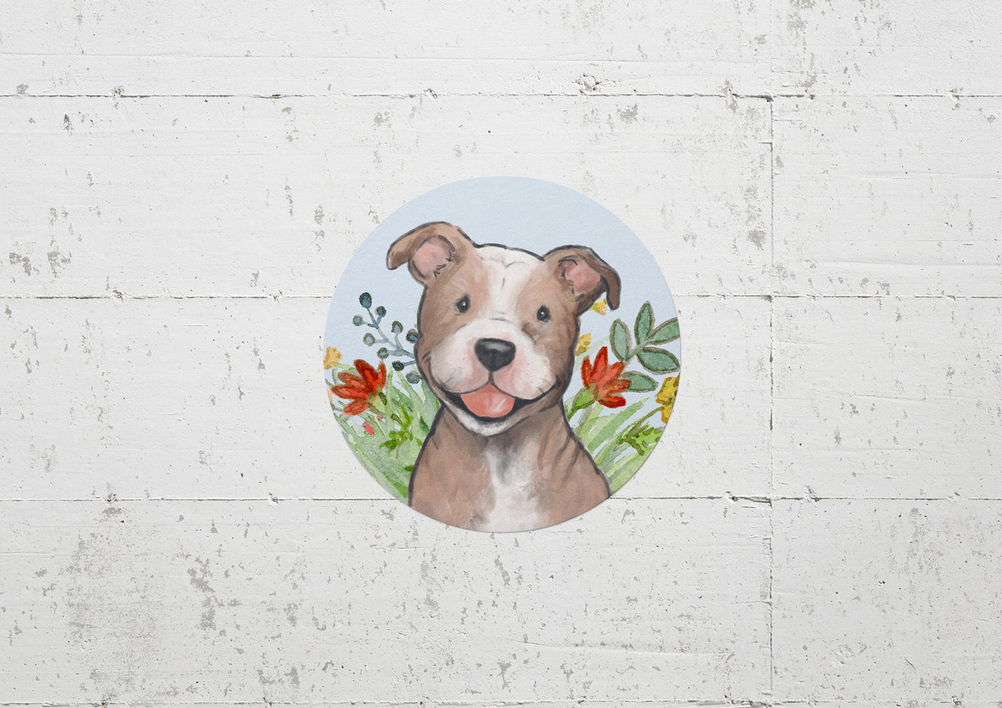 Circle sticker with a happy pitbull dog and flowers on a light blue background.
