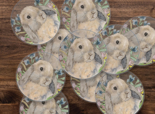 Circle stickers with a blue tort holland lop bunny and flowers on them.