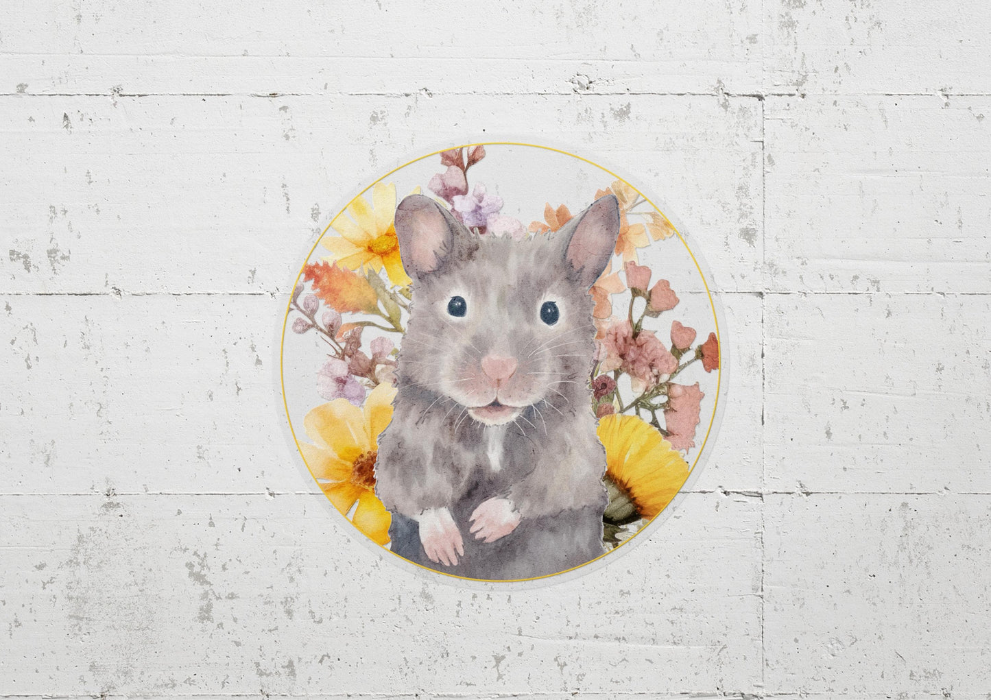 Round sticker with a cute, gray Syrian hamster and yellow and pink flowers on a transparent background