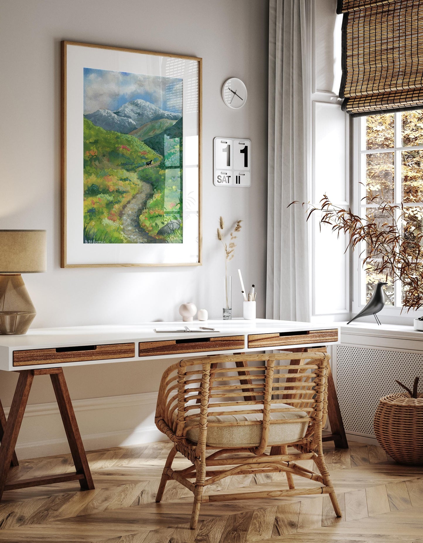 Framed colorful gouache landscape of Bernese Mountain Dog hiking on a trail in the Alaskan Mountains hanging above a desk in a neutral colored office.